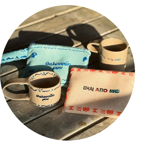 Custom gifts including a wetbag, a cup and a side bag on a picnic table